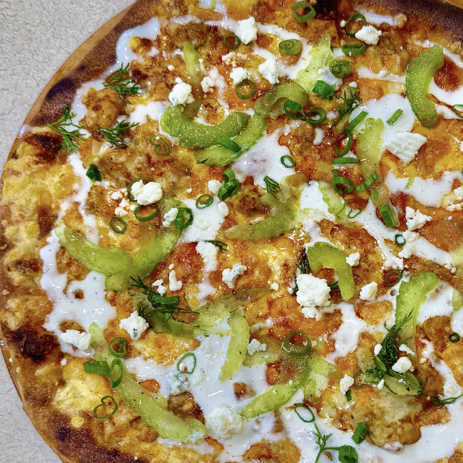 Professional gourmet pizza topped with sliced avocado, crumbled white cheese, green onions, and herbs on crispy crust, ideal for foodservice wholesale suppliers.
