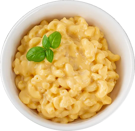 Golden mac and cheese with creamy sauce in white bowl, garnished with fresh basil for professional food service presentation.