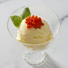 Ice cream topped with caviar in an elegant glass bowl, a unique dessert fusion.